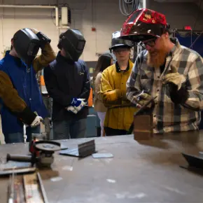 teacher leading demonstration in welding