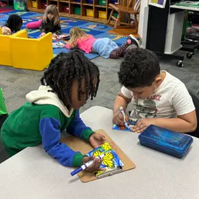 Two elementary students coloring
