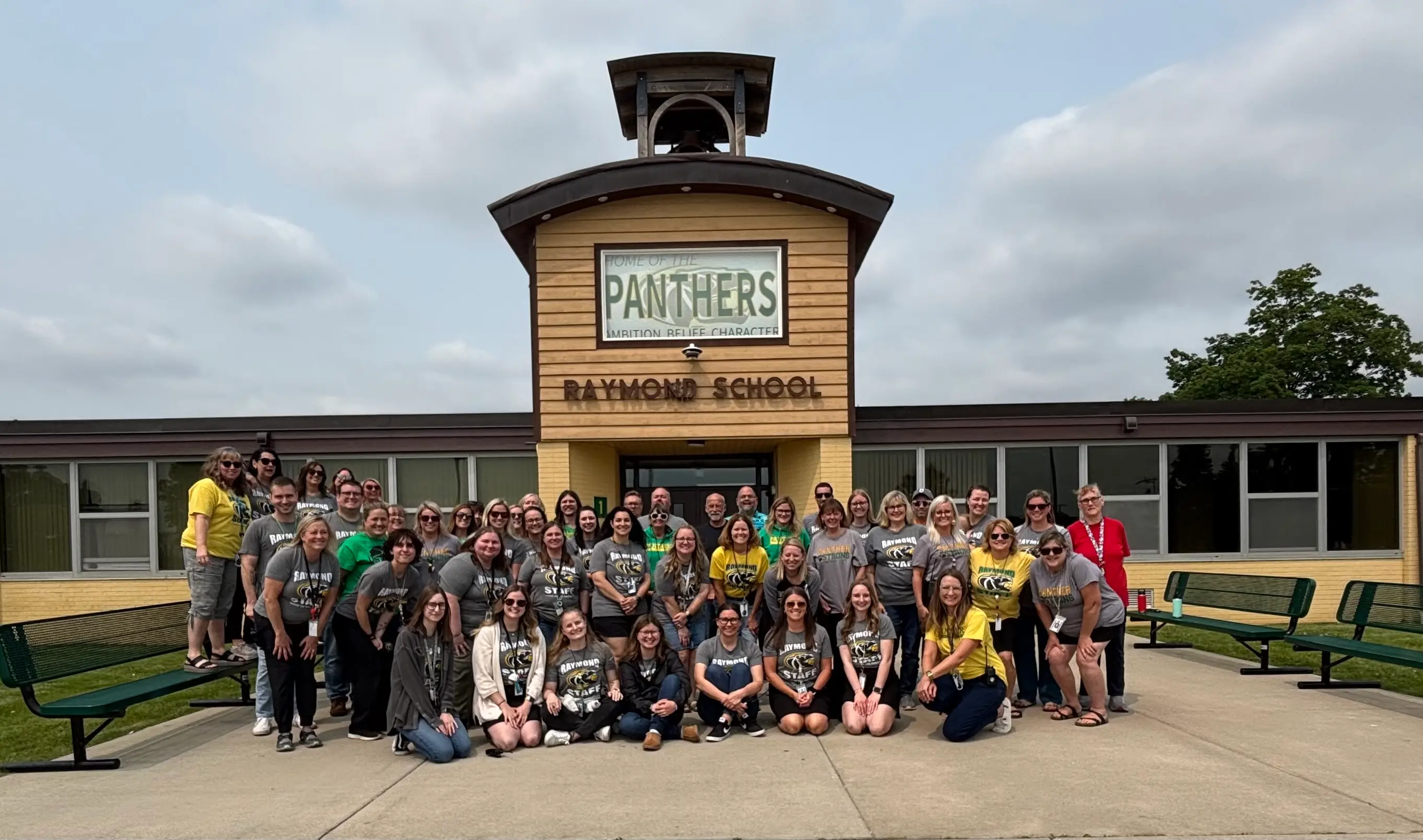 Front of Raymond School with staff in front of it for a group photo
