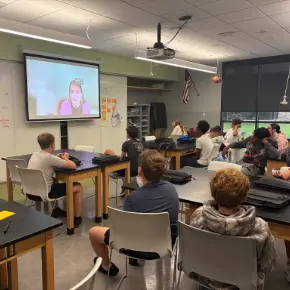 Students in class watching a Zoom presenter