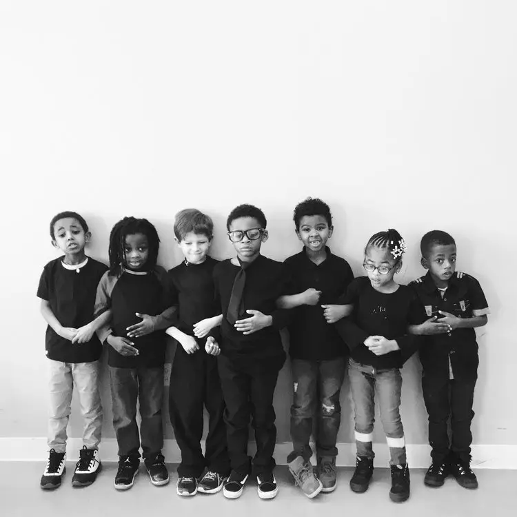 Students standing on a wall