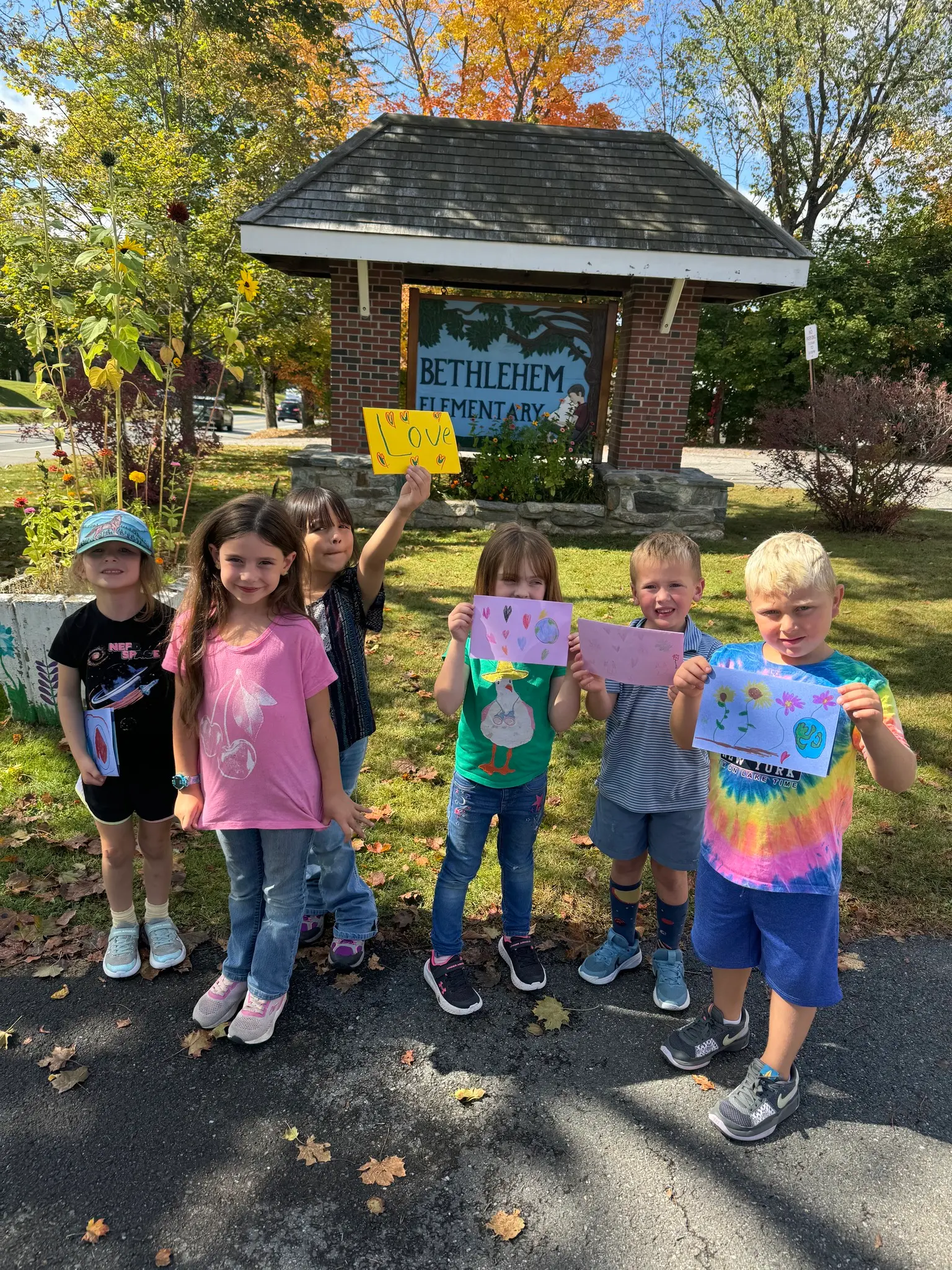 young students standing in front of the Bethlehem School Sign