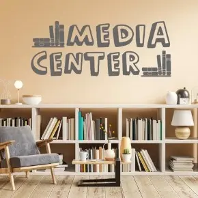Reading room with bookshelves, an armchair, and Media Center lettering on the wall