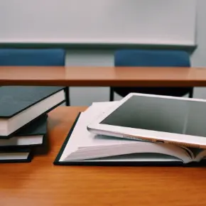 Books and a tablet on a table 
