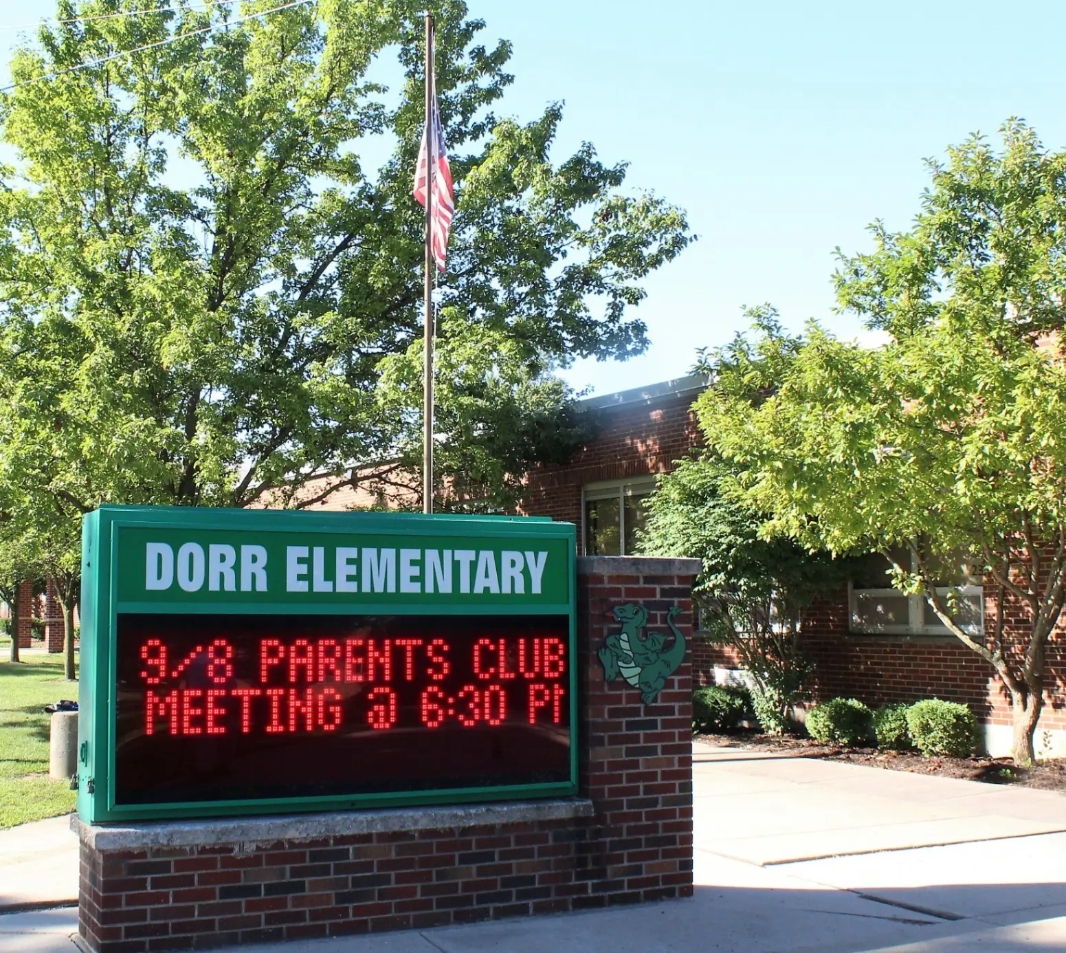 Door Elementary front sign board with Parents Club meeting information displayed