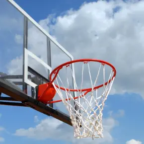 Basketball hoop with sky and clouds behind