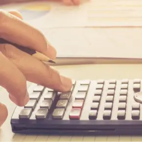 Hand operating a calculator