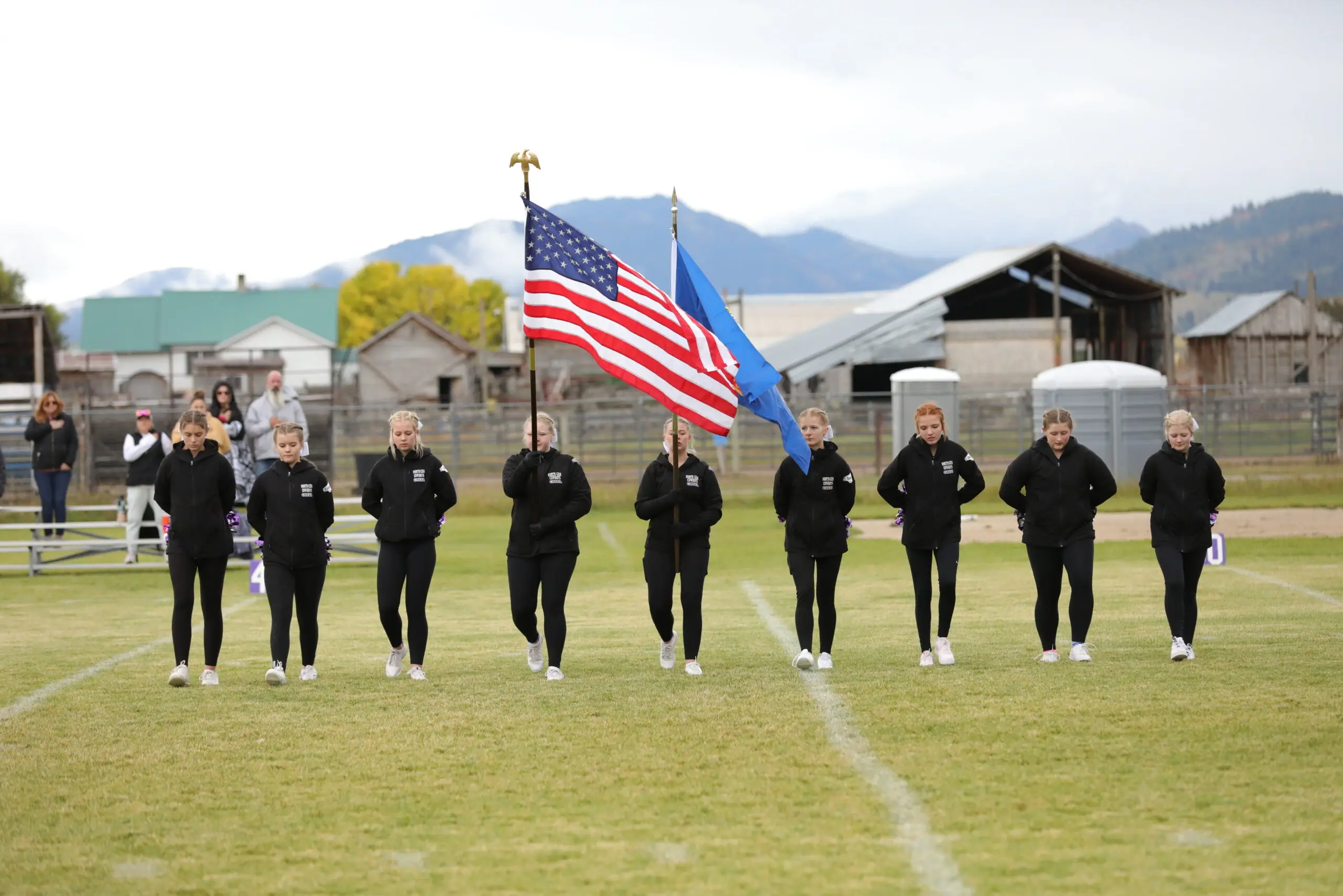 Cheerleaders presenting flags at a football game
