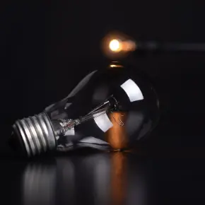 Incandescent lightbulb laying on a flat surface