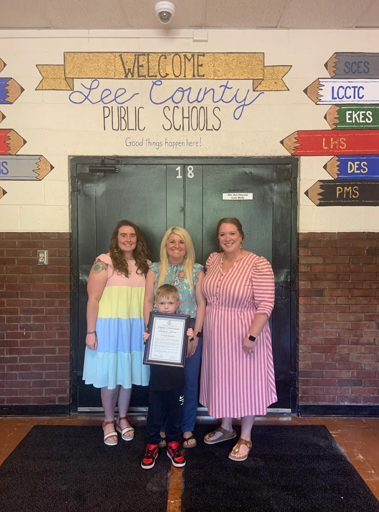 School staff and a student holding up the Exemplar Performance School award