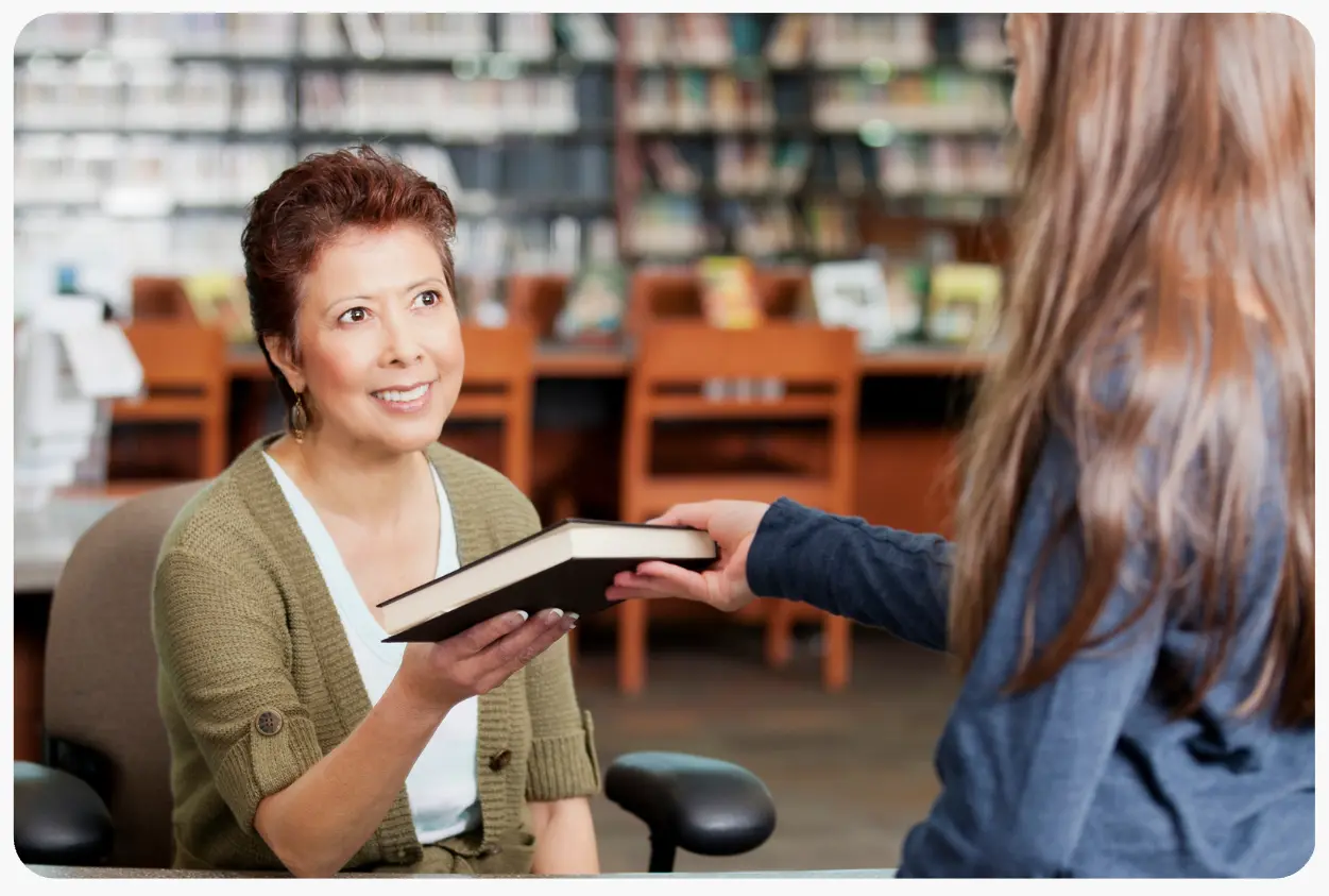 Student checking out a library book