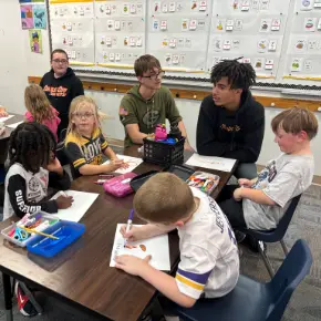 Children drawing and coloring at a table