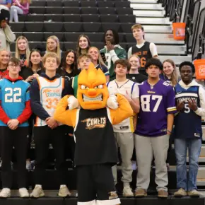 Students and mascot at basketball game