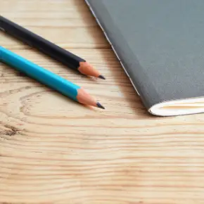 Pencils and a notebook on a table