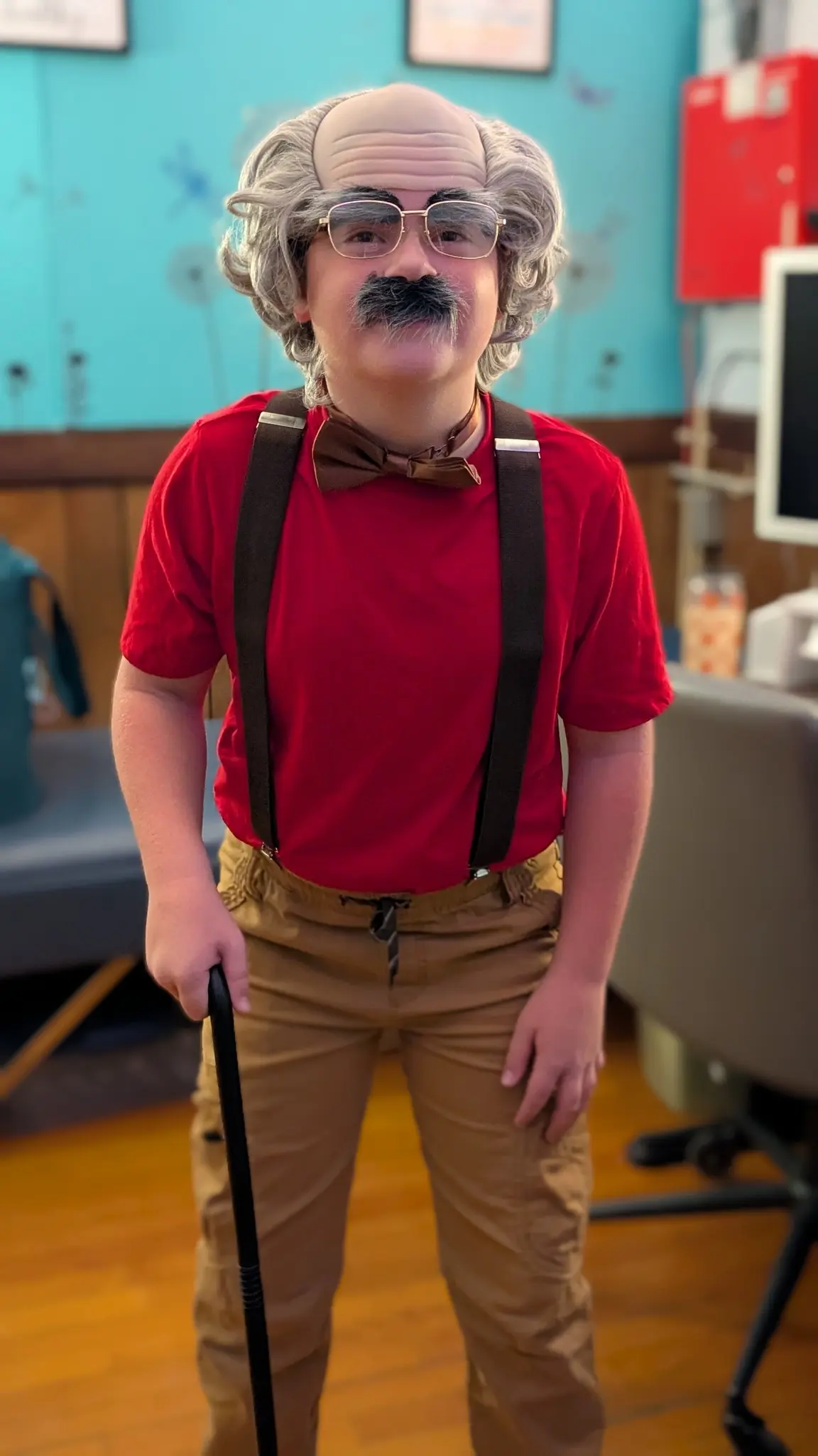 Student with a mask and a cane dressed up for the 100th day of school