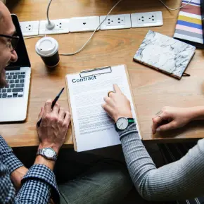 Two people looking over a contract