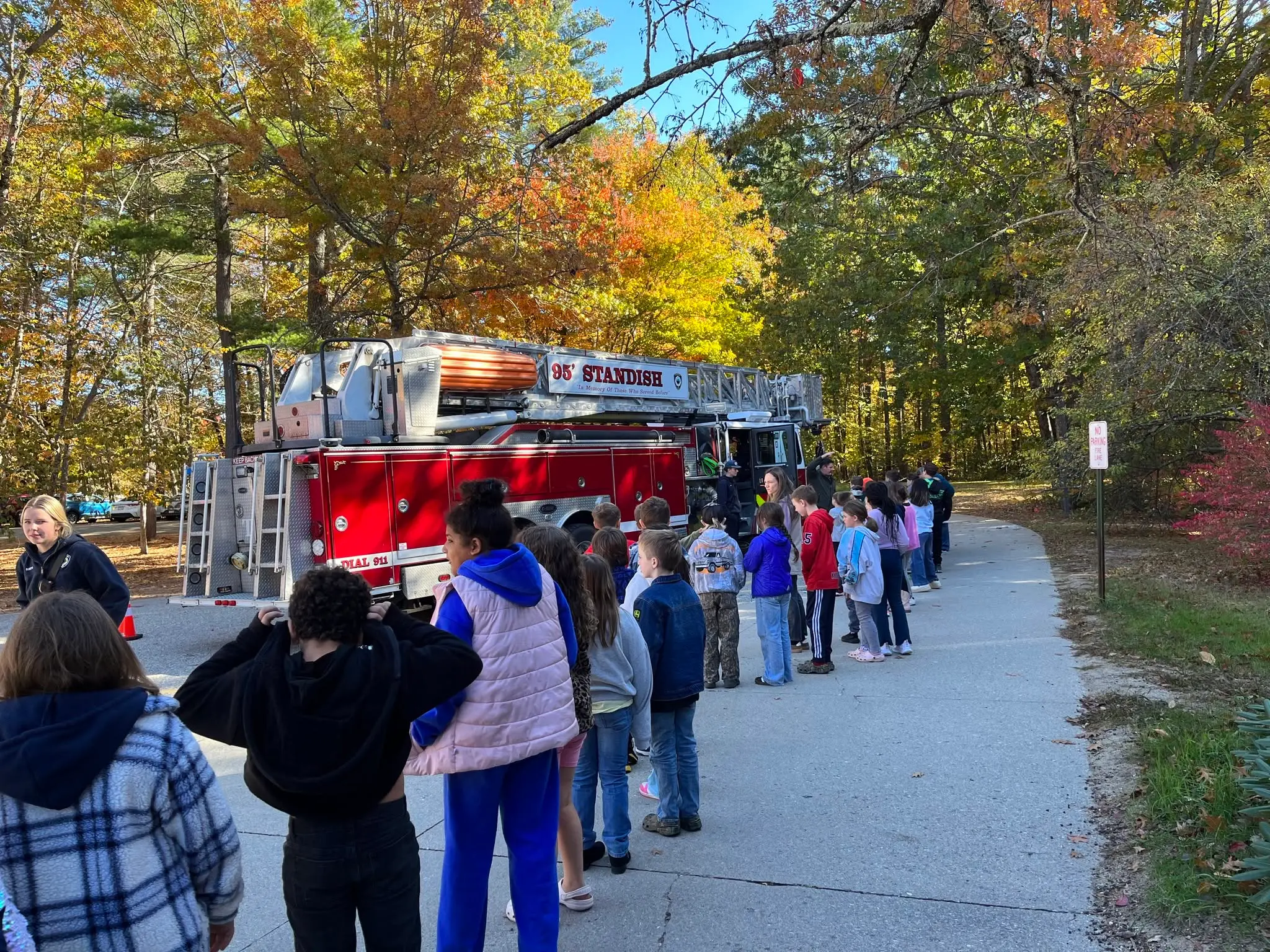 students outside with a firefighter truck
