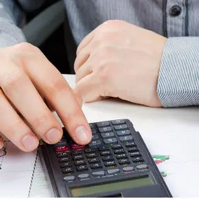 Image of person working on calculator