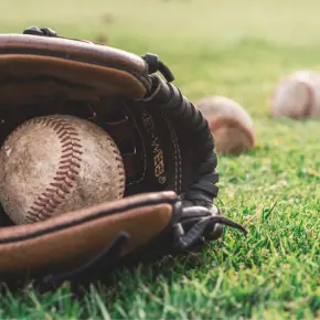 Baseball in a glove on the grass