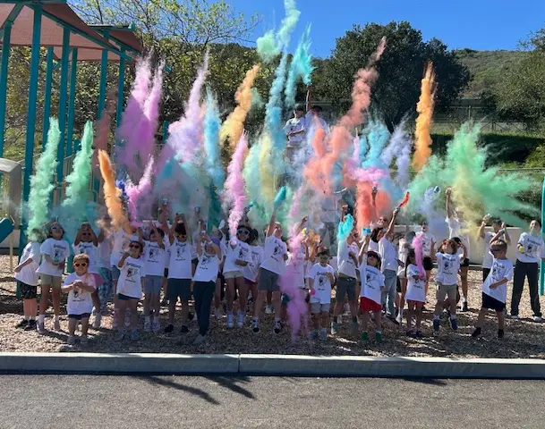 students throwing colored powder